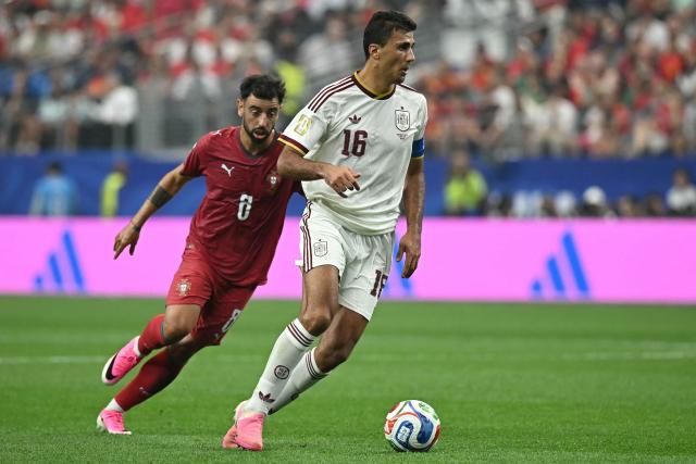 Portugal's midfielder #08 Bruno Fernandes and Spain's midfielder #16 Rodri fight for the ball during the 2026 World Cup round of 16 football match between Portugal and Spain at the Dallas Stadium in Arlington on July 6, 2026. (Photo by Paul ELLIS / AFP)