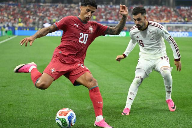 Portugal's defender #20 Joao Cancelo and Spain's midfielder #15 Alex Baena fight for the ball during the 2026 World Cup round of 16 football match between Portugal and Spain at the Dallas Stadium in Arlington on July 6, 2026. (Photo by RONALDO SCHEMIDT / AFP)