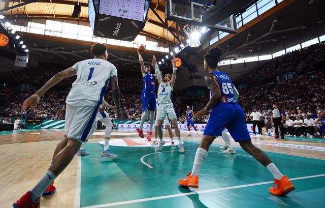 France's Maxime Raynaud (Centre L) attempts to score during the qualifier basketball match between France and Finland for the men's 2027 FIBA World Championships at the Palais des Sports in Pau south-western France, on July 6, 2026. (Photo by Gaizka IROZ / AFP)