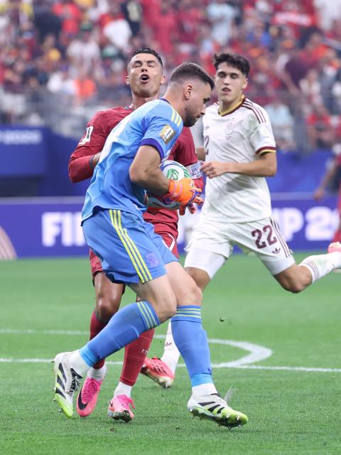 Spain's goalkeeper #23 Unai Simon grabs the ball past Portugal's forward #07 Cristiano Ronaldo during the 2026 World Cup round of 16 football match between Portugal and Spain at the Dallas Stadium in Arlington on July 6, 2026. (Photo by Thomas COEX / AFP)