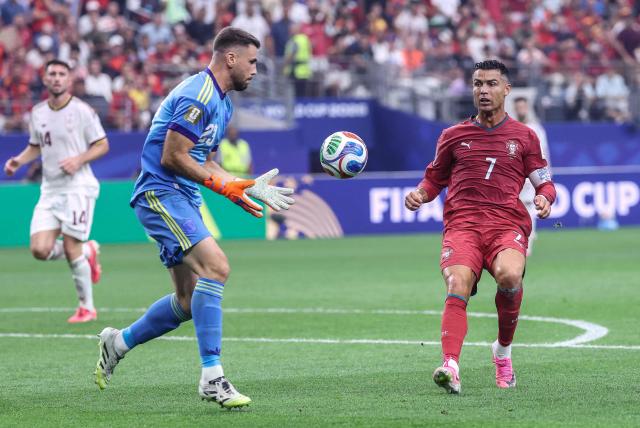 Spain's goalkeeper #23 Unai Simon grabs the ball past Portugal's forward #07 Cristiano Ronaldo during the 2026 World Cup round of 16 football match between Portugal and Spain at the Dallas Stadium in Arlington on July 6, 2026. (Photo by Thomas COEX / AFP)