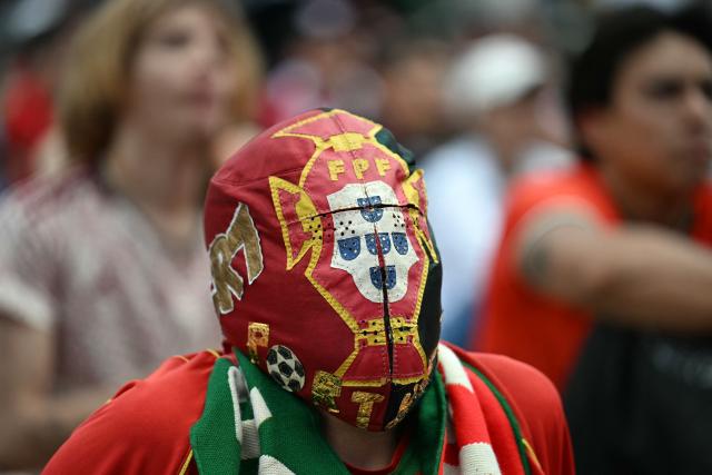 A fan of Portugal wears a mask at the FIFA Fan Fest during the 2026 FIFA World Cup round-of-16 football match between Portugal and Spain at the Zocalo square in Mexico City, Mexico, on July 6, 2026 (Photo by YURI CORTEZ / AFP)