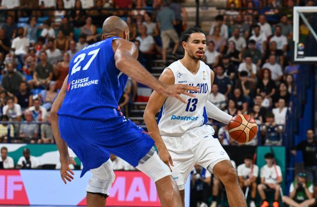 Finland's #13 Olivier Nkamhoua (R) dribbles to pass France's center #27 Rudy Gobert during the qualifier basketball match between France and Finland for the men's 2027 FIBA World Championships at the Palais des Sports in Pau, south-western France on July 6, 2026. (Photo by Gaizka IROZ / AFP)