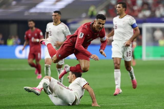 Portugal's forward #07 Cristiano Ronaldo falls on the ground past Spain's forward #21 Mikel Oyarzabal during the 2026 World Cup round of 16 football match between Portugal and Spain at the Dallas Stadium in Arlington on July 6, 2026. (Photo by Aric Becker / AFP)