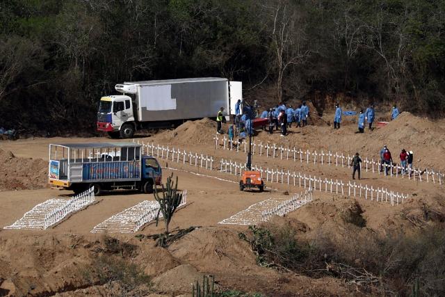 Workers prepare graves for victims of the June 24 earthquake at La Esperanza Cemetery in Carayaca, La Guaira state, northeast of Caracas, on July 5, 2026. The twin earthquakes that struck Venezuela on June 24 have claimed the lives of at least 3,535 people, the Venezuelan government reported on July 5. (Photo by Lucas AGUAYO / AFP)