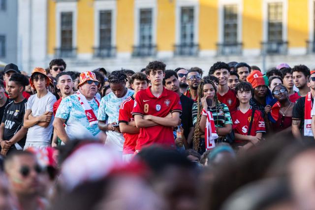 Portugal supporter react while viewing the Portugal versus Spain 2026 World Cup round of 16 football match played in Arlington, Texas, at the fan zone in Praca do Comercio in Lisbon on July 6, 2026. (Photo by HENRIQUE CASINHAS / AFP)