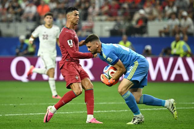 Spain's goalkeeper #23 Unai Simon catches the ball next to Portugal's forward #07 Cristiano Ronaldo during the 2026 World Cup round of 16 football match between Portugal and Spain at the Dallas Stadium in Arlington on July 6, 2026. (Photo by Paul ELLIS / AFP)