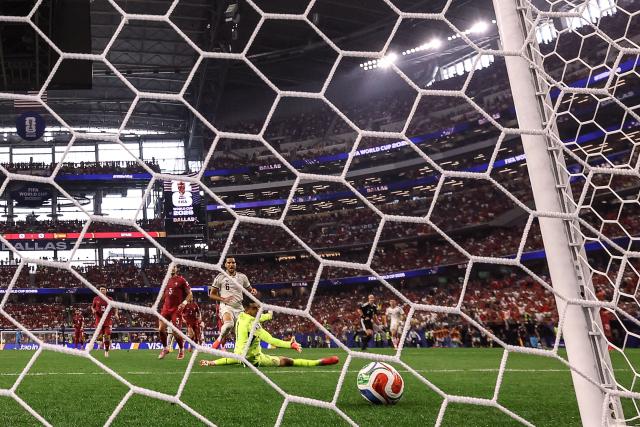 Spain's midfielder #06 Mikel Merino scores his team's first goal past Portugal's goalkeeper #01 Diogo Costa during the 2026 World Cup round of 16 football match between Portugal and Spain at the Dallas Stadium in Arlington on July 6, 2026. (Photo by Thomas COEX / AFP)