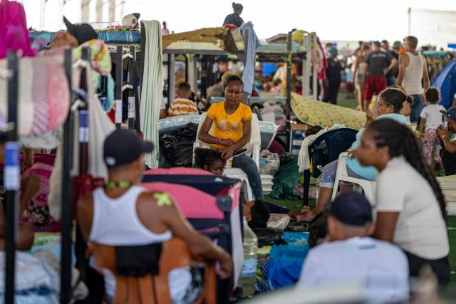 People displaced by the June 24 earthquake rest on bunk beds inside a temporary shelter set up at the Jose Maria Vargas sports complex in Catia la Mar, La Guaira state, Venezuela, on July 6, 2026. The twin earthquakes that struck Venezuela on June 24 have claimed the lives of at least 3,535 people, the Venezuelan government reported on July 5. (Photo by Miguel MEDINA / AFP)
