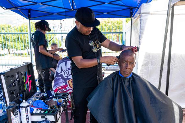 A displaced man has his hair cut at a temporary shelter set up at the Jose Maria Vargas sports complex in Catia la Mar, La Guaira state, Venezuela, on July 6, 2026, following the June 24 earthquake. The twin earthquakes that struck Venezuela on June 24 have claimed the lives of at least 3,535 people, the Venezuelan government reported on July 5. (Photo by Miguel MEDINA / AFP)