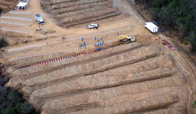This aerial view shows plots containing the coffins of victims of the June 24 earthquakes, at La Esperanza Cemetery in Carayaca, La Guaira state, northeast of Caracas, on July 6, 2026. Up to now, the twin earthquakes that struck Venezuela have claimed the lives of 3,535 people, the Venezuelan government reported. (Photo by Miguel MEDINA / AFP)