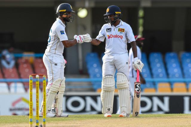 Dinesh Chandimal (L) and Kamindu Mendis (R) of Sri Lanka celebrate their 50-run partnership during the 4th day of the 2nd Test between Sri Lanka and West Indies at Vivian Richards Cricket Stadium in North Sound, Antigua and Barbuda, on July 6, 2026. (Photo by Randy Brooks / AFP)