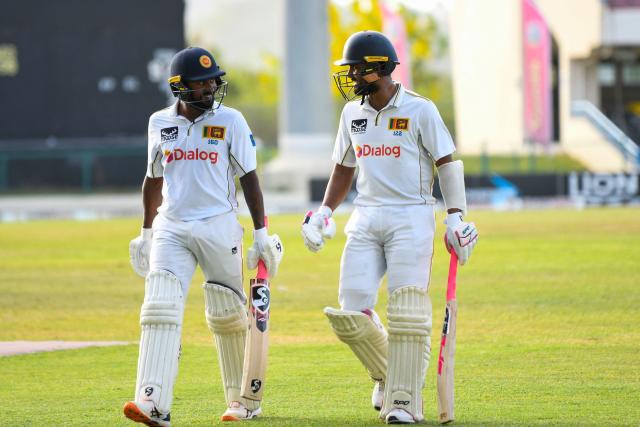 Kamindu Mendis (L) and Dinesh Chandimal (R) of Sri Lanka walk off the field at the end of the 4th day of the 2nd Test between Sri Lanka and West Indies at Vivian Richards Cricket Stadium in North Sound, Antigua and Barbuda, on July 6, 2026. (Photo by Randy Brooks / AFP)