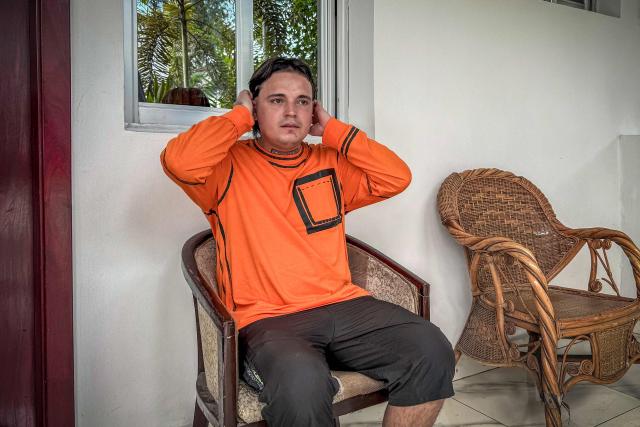 (FILES) Hugo Palencia Ropero, 25, a Colombian national expelled from the United States, sits outside his room at a hotel in Kinshasa on April 22, 2026. The United States is using visa bans and restrictions on African countries to strongarm them into taking people from third countries as part of Donald Trump's crackdown on immigration, two former State Department officials told AFP.
Lawyers say deportees have been thrown into a "legal black hole", held without charge in countries they have no ties to, and few if any rights in.
Even those deported to stable democracies like Ghana have been abused, dumped by security forces in neighbouring Togo, without papers. (Photo by Glody MURHABAZI / AFP)