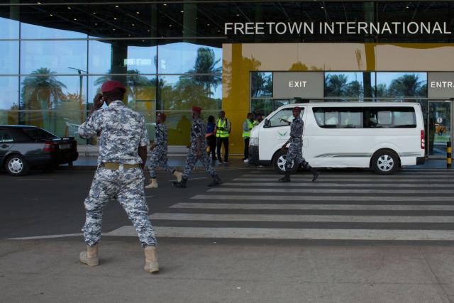 (FILES) Security escort migrants in a National Public Health Agency (NPHA) after their arrival at Freetown International Airport, formerly known as Lungi International Airport, in Lungi on May 20, 2026. The United States is using visa bans and restrictions on African countries to strongarm them into taking people from third countries as part of Donald Trump's crackdown on immigration, two former State Department officials told AFP.
Lawyers say deportees have been thrown into a "legal black hole", held without charge in countries they have no ties to, and few if any rights in.
Even those deported to stable democracies like Ghana have been abused, dumped by security forces in neighbouring Togo, without papers. (Photo by AFP)