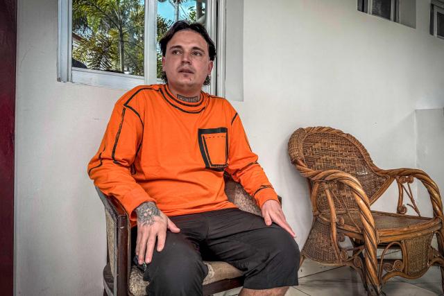 (FILES) Hugo Palencia Ropero, 25, a Colombian national expelled from the United States, sits outside his room at a hotel in Kinshasa on April 22, 2026. The United States is using visa bans and restrictions on African countries to strongarm them into taking people from third countries as part of Donald Trump's crackdown on immigration, two former State Department officials told AFP.
Lawyers say deportees have been thrown into a "legal black hole", held without charge in countries they have no ties to, and few if any rights in.
Even those deported to stable democracies like Ghana have been abused, dumped by security forces in neighbouring Togo, without papers. (Photo by Glody MURHABAZI / AFP)