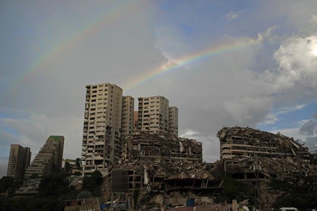 A rainbow appears above buildings damaged by the June 24 earthquakes in Catia la Mar, La Guaira state, Venezuela, on July 6, 2026. The twin earthquakes that struck Venezuela on June 24 have claimed the lives of at least 3,535 people, the Venezuelan government reported on July 5. (Photo by Juan BARRETO / AFP)
