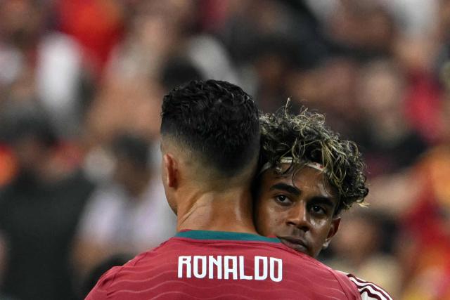 Portugal's forward #07 Cristiano Ronaldo and Spain's forward #19 Lamine Yamal embrace each other after the 2026 World Cup round of 16 football match between Portugal and Spain at the Dallas Stadium in Arlington on July 6, 2026. (Photo by RONALDO SCHEMIDT / AFP)