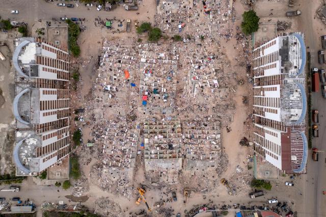 This aerial view shows collapsed buildings in Caraballeda, La Guaira state, Venezuela, on July 6, 2026, following the June 24 earthquakes. The twin earthquakes that struck Venezuela on June 24 have claimed the lives of at least 3,535 people, the Venezuelan government reported on July 6. (Photo by Federico PARRA / AFP)
