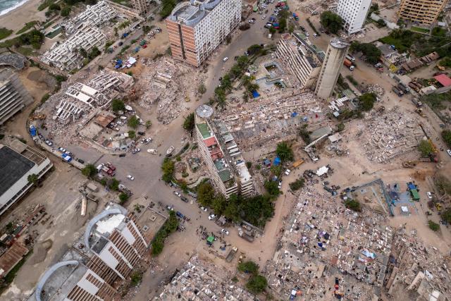 This aerial view shows collapsed buildings in Caraballeda, La Guaira state, Venezuela, on July 6, 2026, following the June 24 earthquakes. The twin earthquakes that struck Venezuela on June 24 have claimed the lives of at least 3,535 people, the Venezuelan government reported on July 6. (Photo by Federico PARRA / AFP)
