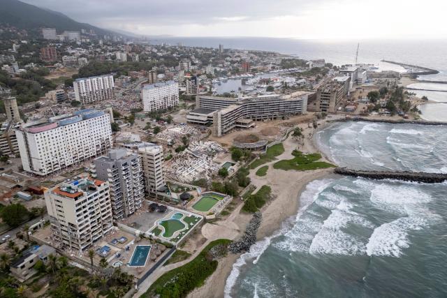 This aerial view shows several collapsed buildings along the coastal strip in Caraballeda, La Guaira state, Venezuela, on July 6, 2026, following the June 24 earthquakes. The twin earthquakes that struck Venezuela on June 24 have claimed the lives of at least 3,535 people, the Venezuelan government reported on July 6. (Photo by Federico PARRA / AFP)