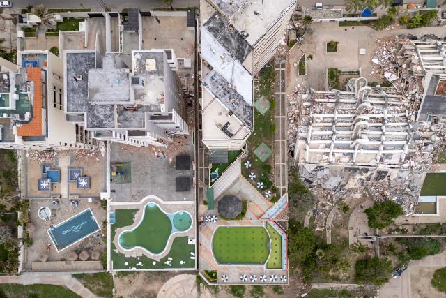 This aerial view shows a collapsed building in Caraballeda, La Guaira state, Venezuela, on July 6, 2026, following the June 24 earthquakes. The twin earthquakes that struck Venezuela on June 24 have claimed the lives of at least 3,535 people, the Venezuelan government reported on July 6. (Photo by Federico PARRA / AFP)