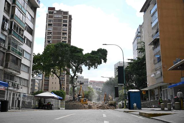 Heavy machinery removes debris form a collapsed building at the Chacao municipality in Caracas, on July 6, 2026, following the June 24 earthquakes that hit the region. The death toll from Venezuela's twin earthquakes has risen to 3,535, with more than 16,700 injured in the disaster, according to updated official figures released on July 6. (Photo by Raul ARBOLEDA / AFP)