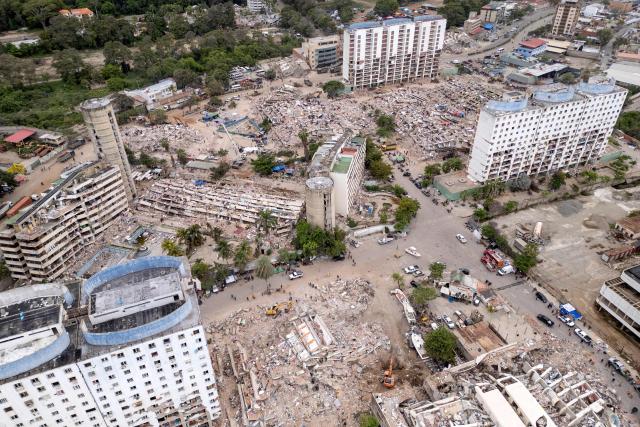 This aerial view shows collapsed buildings in Caraballeda, La Guaira state, Venezuela, on July 6, 2026, following the June 24 earthquakes. The twin earthquakes that struck Venezuela on June 24 have claimed the lives of at least 3,535 people, the Venezuelan government reported on July 6. (Photo by Federico PARRA / AFP)