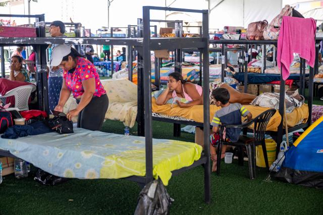 People displaced by the June 24 earthquakes rest on bunk beds inside a temporary shelter set up at the Jose Maria Vargas sports complex in Catia la Mar, La Guaira state, Venezuela, on July 6, 2026. The twin earthquakes that struck Venezuela on June 24 have claimed the lives of at least 3,535 people, the Venezuelan government reported on July 6. (Photo by Miguel MEDINA / AFP)