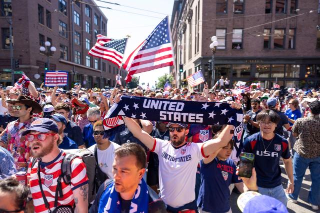US fans march through Pioneer Square before the 2026 World Cup round of 16 match between USA and Belgium in Seattle, Washington, on July 6, 2026. (Photo by Jason Redmond / AFP)