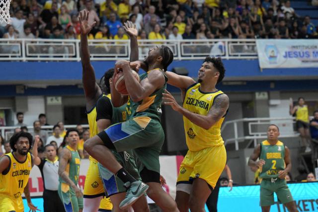Colombia's Samuel Hincapie (R) fouls Brazil's Cristiano Felício during the FIBA Basketball World Cup 2027 Americas qualifiers Group C match between Colombia and Brazil, at the Evangelista Mora Colisseum in Cali, Valle del Cauca, Colombia, on July 6, 2026. (Photo by JOAQUIN SARMIENTO / AFP)