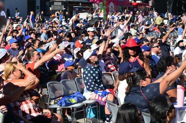 Fans react while watching the 2026 World Cup round of 16 match between USA and Belgium at the Pasadena Civic Auditorium Plaza fan zone in Pasadena, California, on July 6, 2026. (Photo by Frederic J. Brown / AFP)