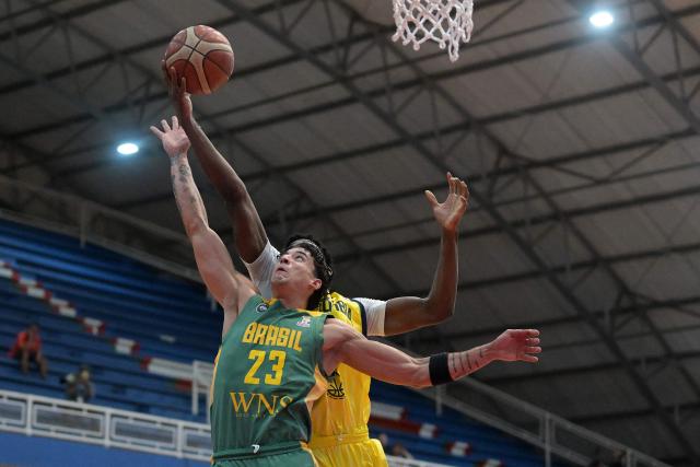 Brazil's Caio Pacheco (front) defends against Colombia's Cristian Solis during the FIBA Basketball World Cup 2027 Americas qualifiers Group C match between Colombia and Brazil, at the Evangelista Mora Colisseum in Cali, Valle del Cauca, Colombia, on July 6, 2026. (Photo by JOAQUIN SARMIENTO / AFP)