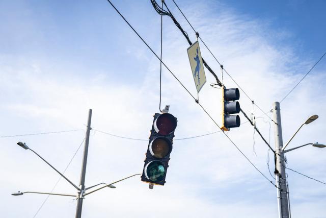 A traffic signal hangs from its support after being dislodged by strong winds brought by Typhoon Bavi in Guam on July 7, 2026. (Photo by Yuichi YAMAZAKI / AFP)