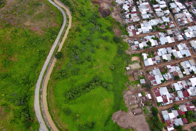 This aerial view shows what is popularly known as the Canal de la Muerte (Death Canal), in northwest Guayaquil, Ecuador, on June 12, 2026. Hundreds of bodies linked to kidnapping victims, criminal acts, and clashes between gangs have been found at he Canal de la Muerte -a section of the Daule–Santa Elena transfer canal. (Photo by MARCOS PIN / AFP)