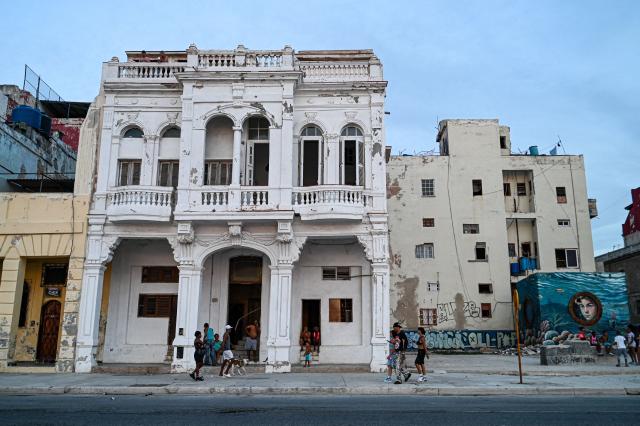 Cuban families remain outside their houses during a nationwide blackout in Havana on July 6, 2026. Cuba on July 6 suffered its third nationwide power outage since the start of the year, the state electricity company said. The impoverished island was already struggling to keep the lights on before US President Donald Trump in January imposed an oil blockade, which has depleted the already dwindling supply of fuel for Cuba's power plants. (Photo by ADALBERTO ROQUE / AFP)