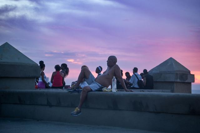 People gather at the Malecon during a nationwide blackout in Havana on July 6, 2026. Cuba on July 6 suffered its third nationwide power outage since the start of the year, the state electricity company said. The impoverished island was already struggling to keep the lights on before US President Donald Trump in January imposed an oil blockade, which has depleted the already dwindling supply of fuel for Cuba's power plants. (Photo by ADALBERTO ROQUE / AFP)