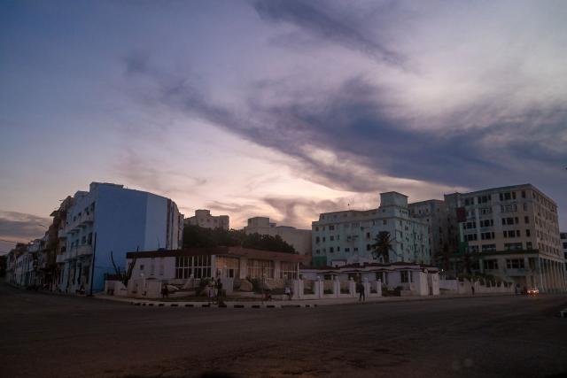Buildings stand in darkness along the Malecon during a nationwide blackout in Havana on July 6, 2026. Cuba on July 6 suffered its third nationwide power outage since the start of the year, the state electricity company said. The impoverished island was already struggling to keep the lights on before US President Donald Trump in January imposed an oil blockade, which has depleted the already dwindling supply of fuel for Cuba's power plants. (Photo by ADALBERTO ROQUE / AFP)