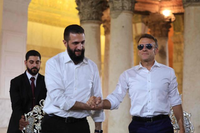 France's President Emmanuel Macron (R) shakes hands with Syrian President Ahmed Al-Charaa during a visit to the Umayyad Mosque in Damascus, on July 6, 2026. French President Emmanuel Macron arrived in Damascus on July 6, 2026 for the first visit by a Western European head of state since Syria's new authorities took power in 2024, an AFP journalist said. Macron, who will depart on July 7, 2026, will advocate for "a free, pluralist Syria that respects each of its components" and plays a role in moderating Middle East tensions, the French presidency told journalists ahead of his arrival. (Photo by Ludovic MARIN / AFP)