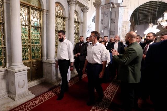 France's President Emmanuel Macron (C) and Syrian President Ahmed Al-Charaa (L) walk past the tomb of St. John The Baptist during a visit to the Umayyad Mosque in Damascus, on July 6, 2026. French President Emmanuel Macron arrived in Damascus on July 6, 2026 for the first visit by a Western European head of state since Syria's new authorities took power in 2024, an AFP journalist said. Macron, who will depart on July 7, 2026, will advocate for "a free, pluralist Syria that respects each of its components" and plays a role in moderating Middle East tensions, the French presidency told journalists ahead of his arrival. (Photo by Ludovic MARIN / AFP)