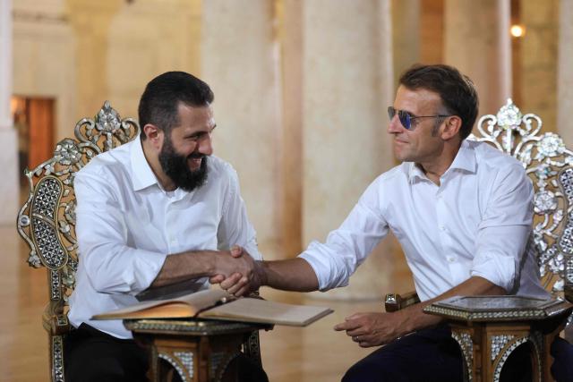 France's President Emmanuel Macron (R) shakes hands with Syrian President Ahmed Al-Charaa during a visit to the Umayyad Mosque in Damascus, on July 6, 2026. French President Emmanuel Macron arrived in Damascus on July 6, 2026 for the first visit by a Western European head of state since Syria's new authorities took power in 2024, an AFP journalist said. Macron, who will depart on July 7, 2026, will advocate for "a free, pluralist Syria that respects each of its components" and plays a role in moderating Middle East tensions, the French presidency told journalists ahead of his arrival. (Photo by Ludovic MARIN / AFP)