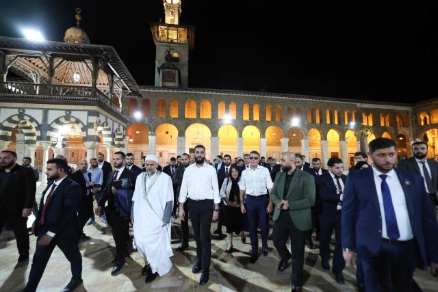 France's President Emmanuel Macron (C/R) and Syrian President Ahmed Al-Charaa (C/L) visit the Umayyad Mosque in Damascus, on July 6, 2026. French President Emmanuel Macron arrived in Damascus on July 6, 2026 for the first visit by a Western European head of state since Syria's new authorities took power in 2024, an AFP journalist said. Macron, who will depart on July 7, 2026, will advocate for "a free, pluralist Syria that respects each of its components" and plays a role in moderating Middle East tensions, the French presidency told journalists ahead of his arrival. (Photo by Ludovic MARIN / AFP)