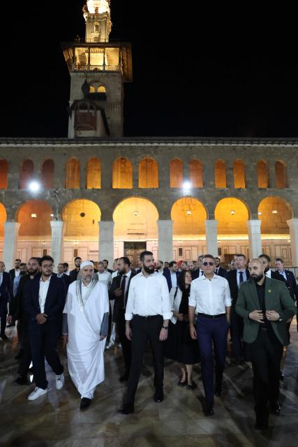 France's President Emmanuel Macron (2nd/R) and Syrian President Ahmed Al-Charaa (C) visit the Umayyad Mosque in Damascus, on July 6, 2026. French President Emmanuel Macron arrived in Damascus on July 6, 2026 for the first visit by a Western European head of state since Syria's new authorities took power in 2024, an AFP journalist said. Macron, who will depart on July 7, 2026, will advocate for "a free, pluralist Syria that respects each of its components" and plays a role in moderating Middle East tensions, the French presidency told journalists ahead of his arrival. (Photo by Ludovic MARIN / AFP)