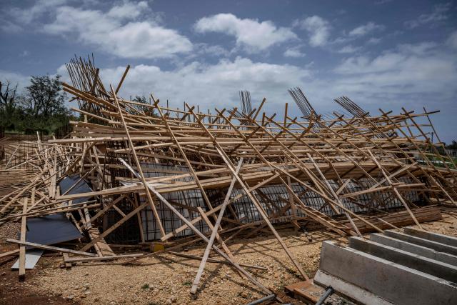 A building under construction lies collapsed after strong winds and heavy rain brought by Super Typhoon Bavi in Guam on July 7, 2026. (Photo by Yuichi YAMAZAKI / AFP)