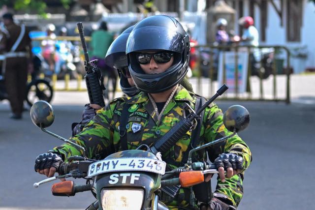Sri Lanka's Special Task Force (STF) personnel patrol outside the Negombo prison on the outskirts of Colombo on July 7, 2026, following clashes between inmates of two drug gangs. Clashes in a Sri Lankan jail have killed 23 people, including four guards, and wounded more than 100 in the country's deadliest prison riot in more than five years, officials said on July 6. (Photo by Ishara S. KODIKARA / AFP)