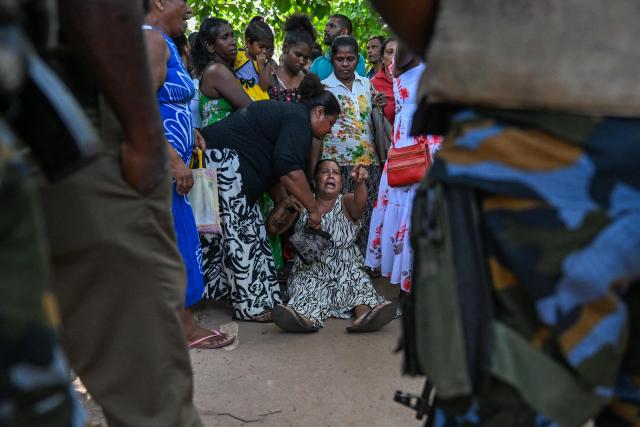 A relative of a victim killed in clashes between inmates of two drug gangs, grieves in front of the Negombo prison on the outskirts of Colombo on July 7, 2026. Clashes in a Sri Lankan jail have killed 23 people, including four guards, and wounded more than 100 in the country's deadliest prison riot in more than five years, officials said on July 6. (Photo by Ishara S. KODIKARA / AFP)