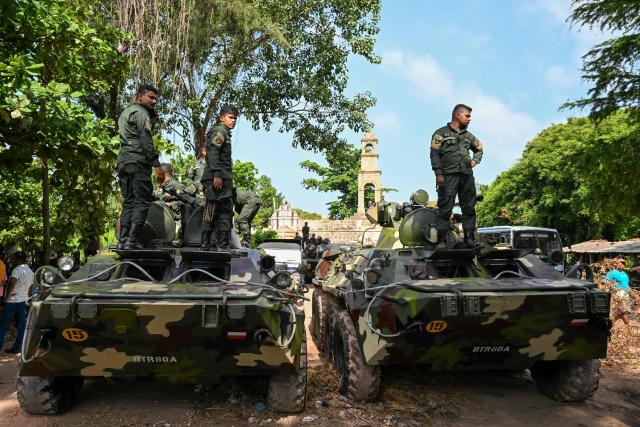 Army officers stand guard outside the Negombo prison on the outskirts of Colombo on July 7, 2026, following clashes between inmates of two drug gangs. Clashes in a Sri Lankan jail have killed 23 people, including four guards, and wounded more than 100 in the country's deadliest prison riot in more than five years, officials said on July 6. (Photo by Ishara S. KODIKARA / AFP)