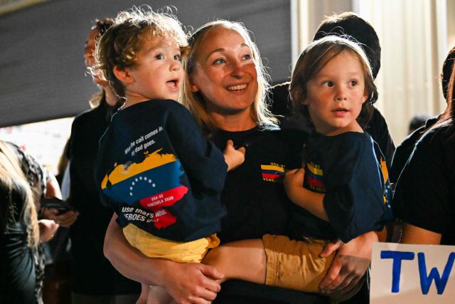 Family members smile as buses arrive with the Los Angeles County Fire Department USA-2 international urban search and rescue team to reunite them with their families after returning from rescue efforts following the earthquakes in Venezuela, at the LACoFD Technical Operations Section in Los Angeles, California, on July 6, 2026. (Photo by Patrick T. Fallon / AFP)