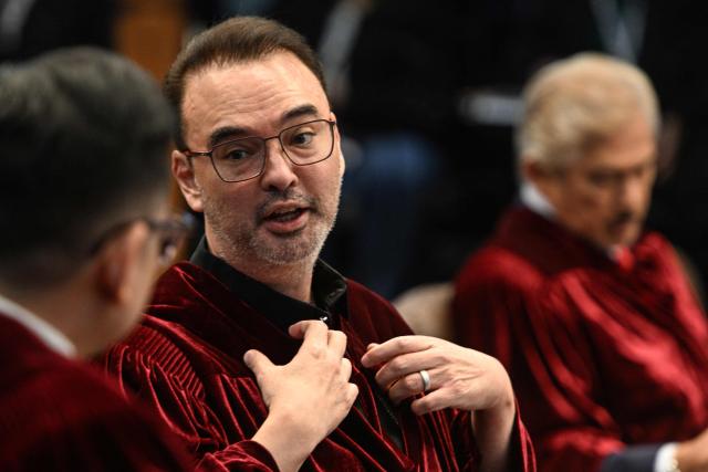 Philippine Senator Alan Peter Cayetano talks to a fellow senator during the impeachment trial of Philippine Vice President Sara Duterte at the Senate of the Philippines in Pasay, Metro Manila on July 7, 2026. (Photo by NOEL CELIS / POOL / AFP)