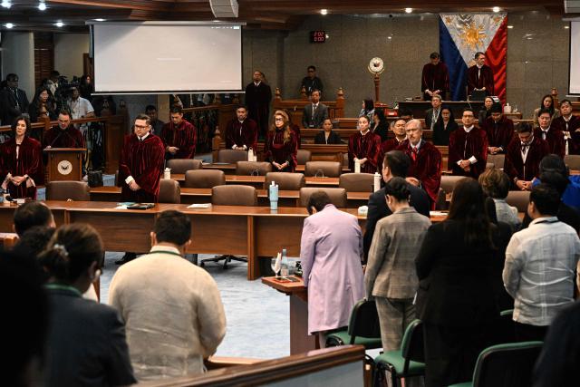 Philippine Senators, acting judges of the impeachment court, pray at the impeachment trial of Philippine Vice President Sara Duterte at the Senate of the Philippines in Pasay, Metro Manila on July 7, 2026. (Photo by NOEL CELIS / POOL / AFP)